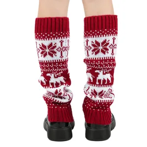Close-up of red Christmas knitted leg warmers with reindeer and snowflake patterns