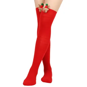 Detailed view of festive red Christmas thigh high socks featuring cute plush reindeer doll decor
