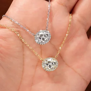 High-quality close-up detail of silver and gold halo necklaces with oval moissanite pendants