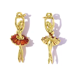 Detail view of gold-plated ballerina pendants with red zirconia stones for DIY jewelry