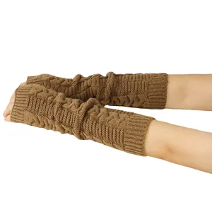 Close-up view of brown knitted fingerless arm warmers with cable knit texture.