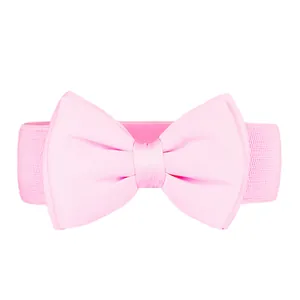 Detail view of a pink elastic belt featuring a large chiffon bowknot for dresses
