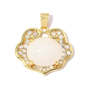 Close-up of gold-plated Ruyi lock pendant featuring a white stone and pavé-set clear zircons