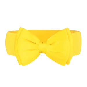 Detail view of a bright yellow elastic belt with a large chiffon bow