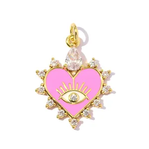 Detailed view of pink heart-shaped evil eye pendant with gold plating and sparkling zircons