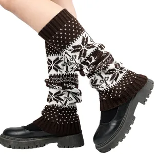 Detail of knitted winter leg warmers featuring a white snowflake pattern on brown