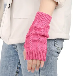 Detaillierte Ansicht der pinken Strickhandschuhe mit Zopfmuster für den Winter.