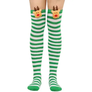 Close-up view of festive green and white striped over-the-knee socks with reindeer