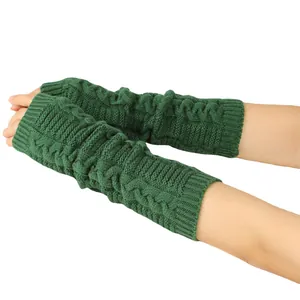 Detail view of dark green long cable knit fingerless arm warmers on female arms