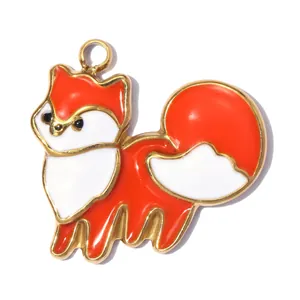 Close-up of orange enamel fox charm with golden stainless steel edges for DIY jewelry.