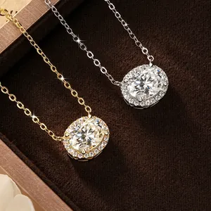 Detailed view of two-tone 2 carat oval moissanite halo pendant necklaces on velvet
