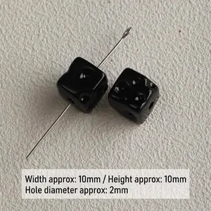 Macro detail of 10mm black acrylic cheese cube beads for DIY jewelry accessories