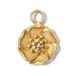 Detailed view of the gold flower pendant with intricate spiral textures on petals