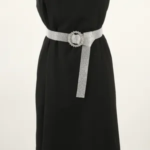 Full rhinestone belt for women styled on a black dress, featuring a sparkling round buckle.