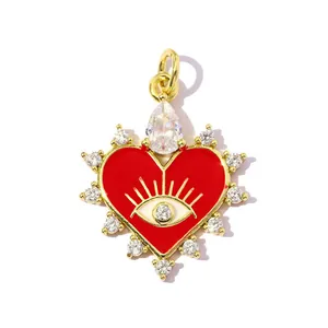 Close-up of 18k gold-plated heart pendant with evil eye motif and sparkling zircon stones.