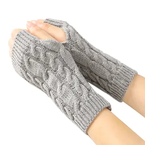 Close-up of grey knitted fingerless gloves with a classic textured cable stitch