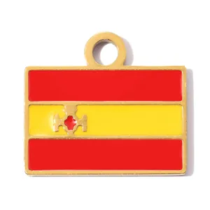 Close-up of a stainless steel Spanish flag pendant with golden trim and enamel colors
