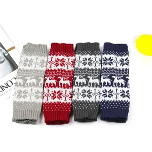 Detailed view of Christmas knitted leg warmers with reindeer and snowflake patterns