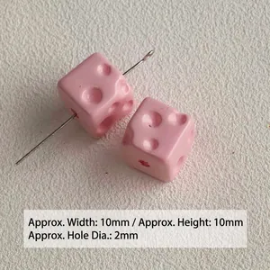 Close-up view of small pink acrylic cheese cube beads for DIY jewelry making accessories