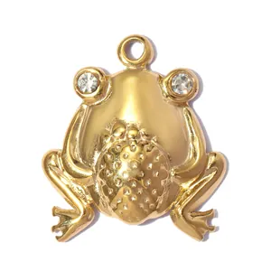Detailed macro view of a gold-plated stainless steel frog pendant charm with stone eyes.