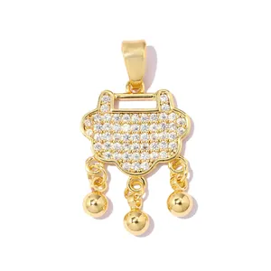 Detailed macro view of a gold-plated safety lock pendant with sparkling zircons