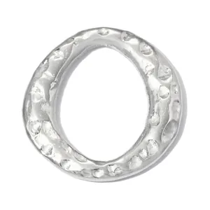 Detail shot of a hammered silver stainless steel circular pendant for DIY jewelry making
