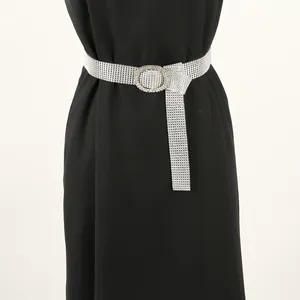 Detailed close-up shot of a sparkling full rhinestone belt with a round buckle on black