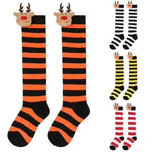 Detailed view of colorful striped Christmas knee-high socks for kids with reindeer dolls