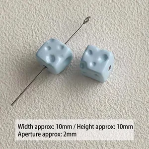 Close-up of small light blue acrylic cheese-shaped beads with 2mm hole