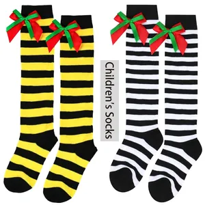 Detail showing red and green double-layered bows on children's striped over-the-knee socks