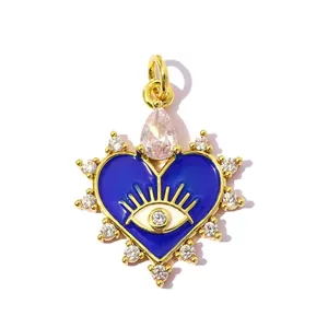 Close-up of heart-shaped evil eye pendant with blue enamel and sparkling zircon accents