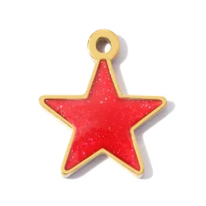 Macro view of a red glitter star pendant with a gold-colored stainless steel frame