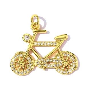 Detailed macro view of a gold-plated bicycle pendant set with clear cubic zirconia