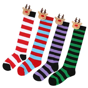 Close-up of colorful striped Christmas long socks with cute 3D reindeer plush dolls