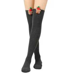 Detailed view of dark grey thigh-high Christmas socks with plush reindeer decoration.