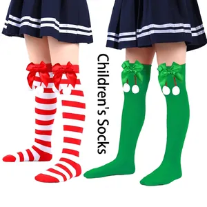 Detailed view of kids' Christmas over-the-knee socks featuring ribbon bows and white pom-poms