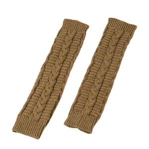Macro view of brown cable-knit long fingerless arm warmer sleeves for cold winter