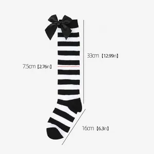 Detailed measurement view of black and white striped knee-high girls' socks with bow