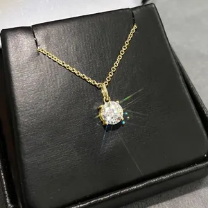 Close-up of sparkling moissanite solitaire pendant necklace in 14k gold plating
