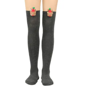 Detailed macro view of gray over-the-knee Christmas socks with 3D reindeer decor