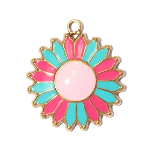 Macro detail of a colorful enamel sunflower pendant with pink and blue petals.