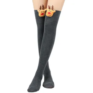Close-up of grey over-the-knee Christmas socks with cute 3D reindeer plush detail