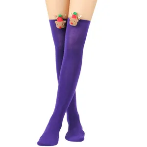 Detail view of purple over-the-knee Christmas socks with plush reindeer decoration