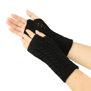 Detail view of black cable knit fingerless gloves with elegant hollow out pattern
