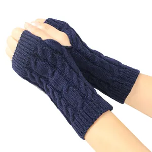Detailed macro view of navy blue cable knit fingerless gloves with soft winter warm texture