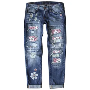 Detailed shot of women's fashion slim-fit ripped denim jeans with floral print patches