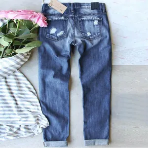 Stylish slim fit blue denim jeans with distressed back pocket details and cuffed hems