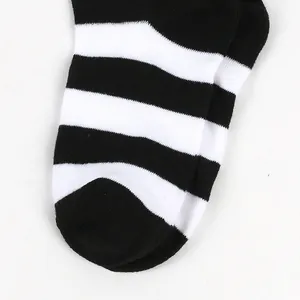 Close-up of black and white striped pattern on children's over-the-knee socks