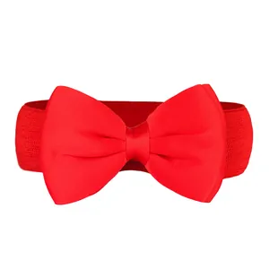 Close-up view of a vibrant red elastic waistband featuring a large chiffon bow