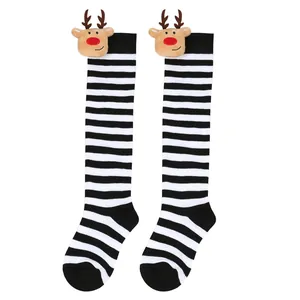 Close-up of children's Christmas knee-high socks featuring cute 3D reindeer doll and stripes